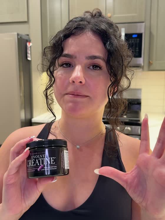 Woman holding Evolve Creatine