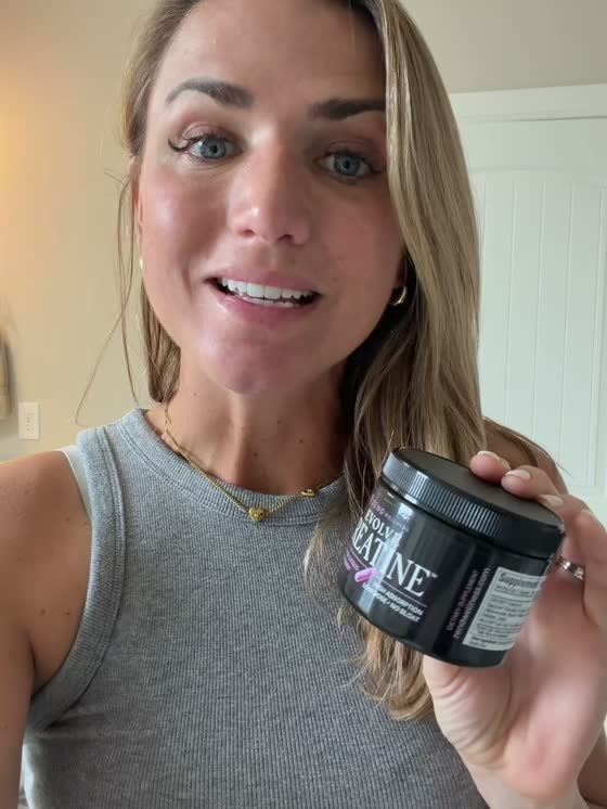 Woman holding Evolve Creatine